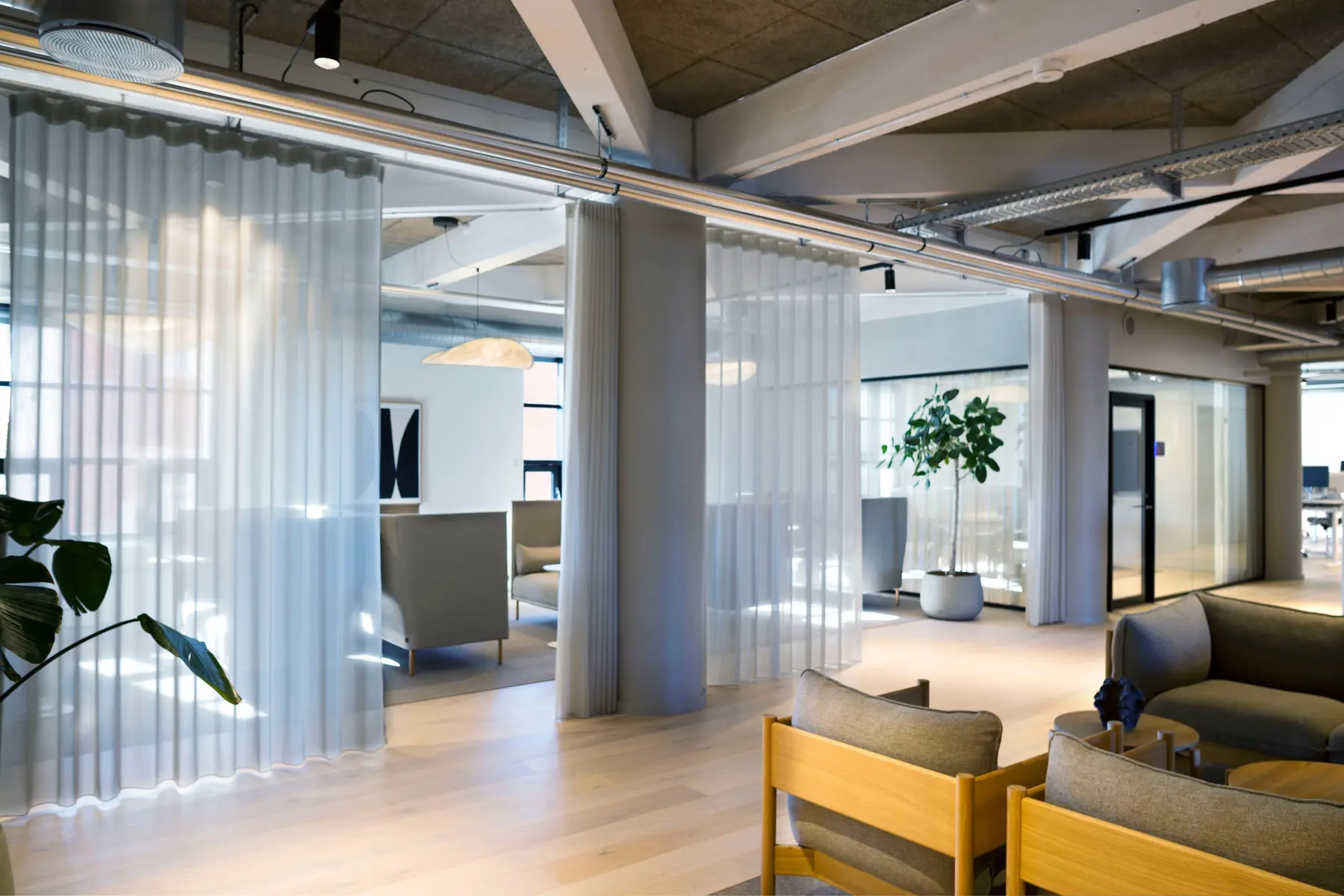 Lounge area in the Copenhagen headquarters with transparent curtains used for zoning