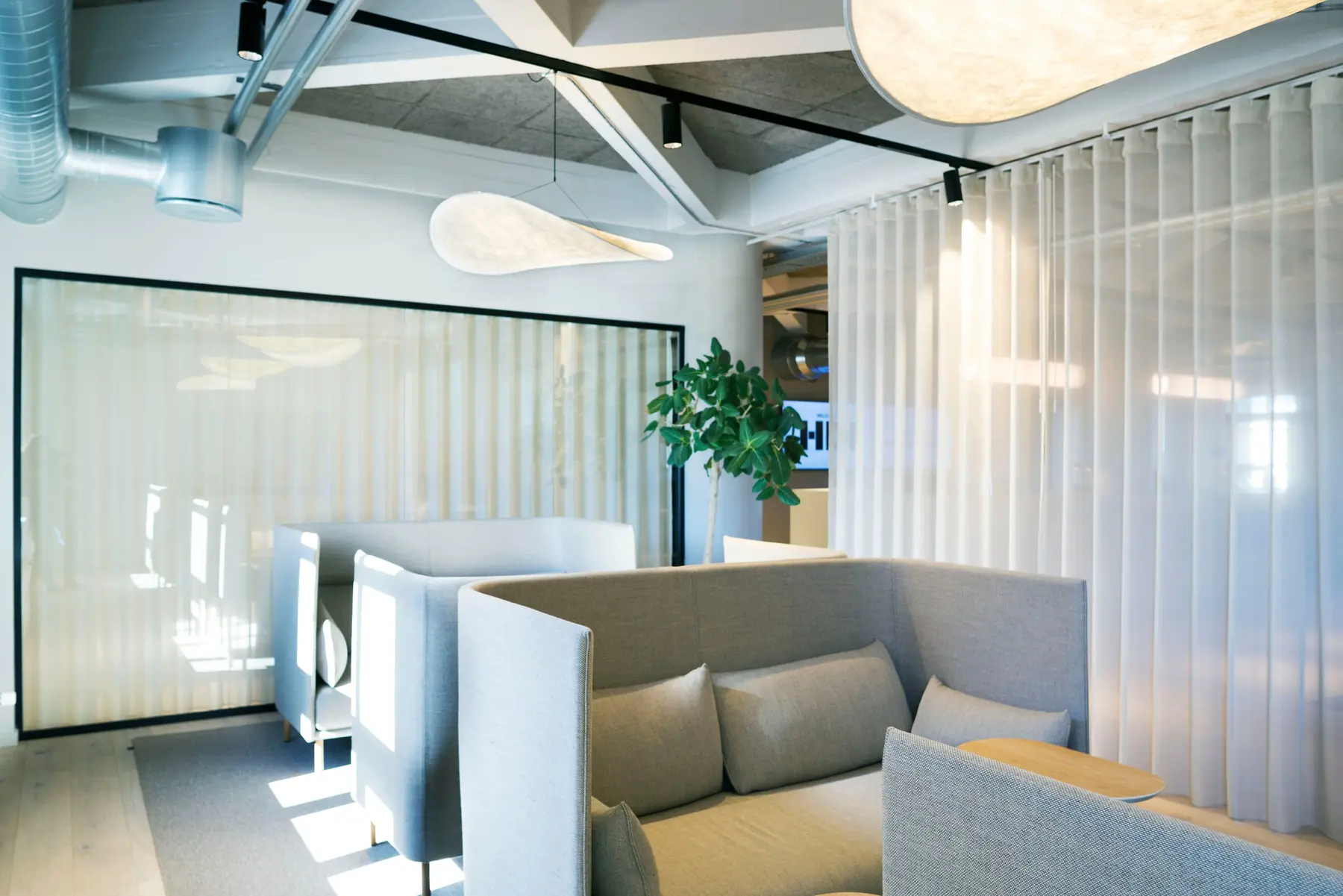 Work and lounge area in the Copenhagen headquarters with transparent curtains