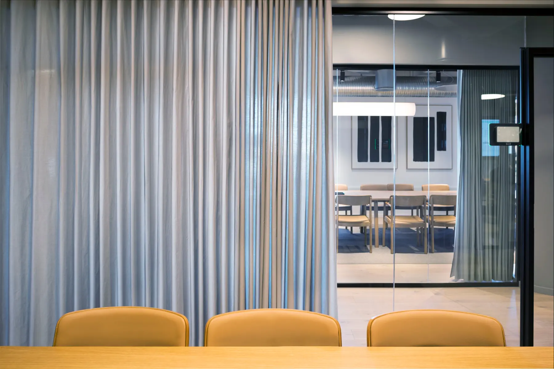 Meeting room in the Copenhagen headquarters seen through transparent curtains