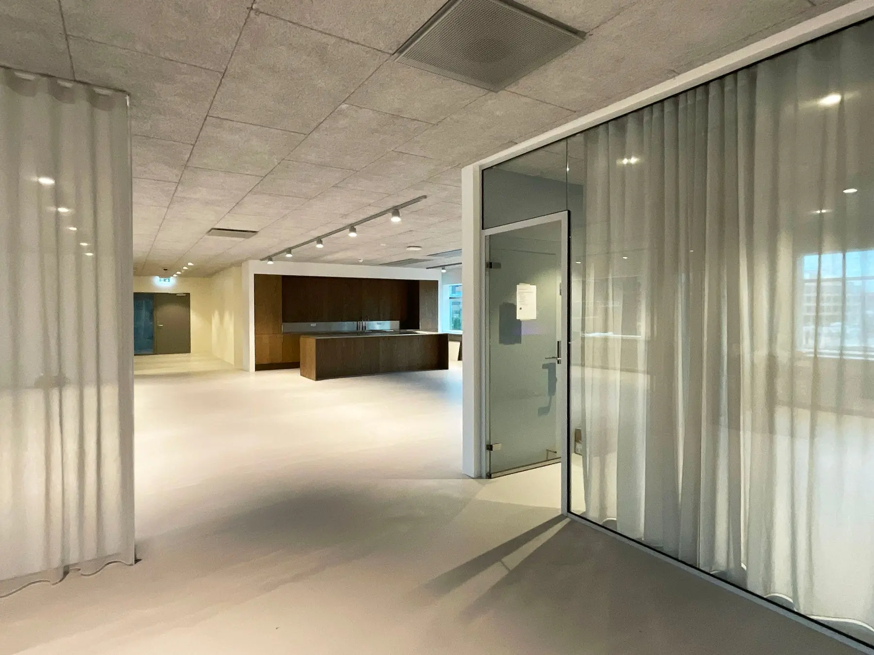 Transparent curtains around glazed areas in the Østerbro office