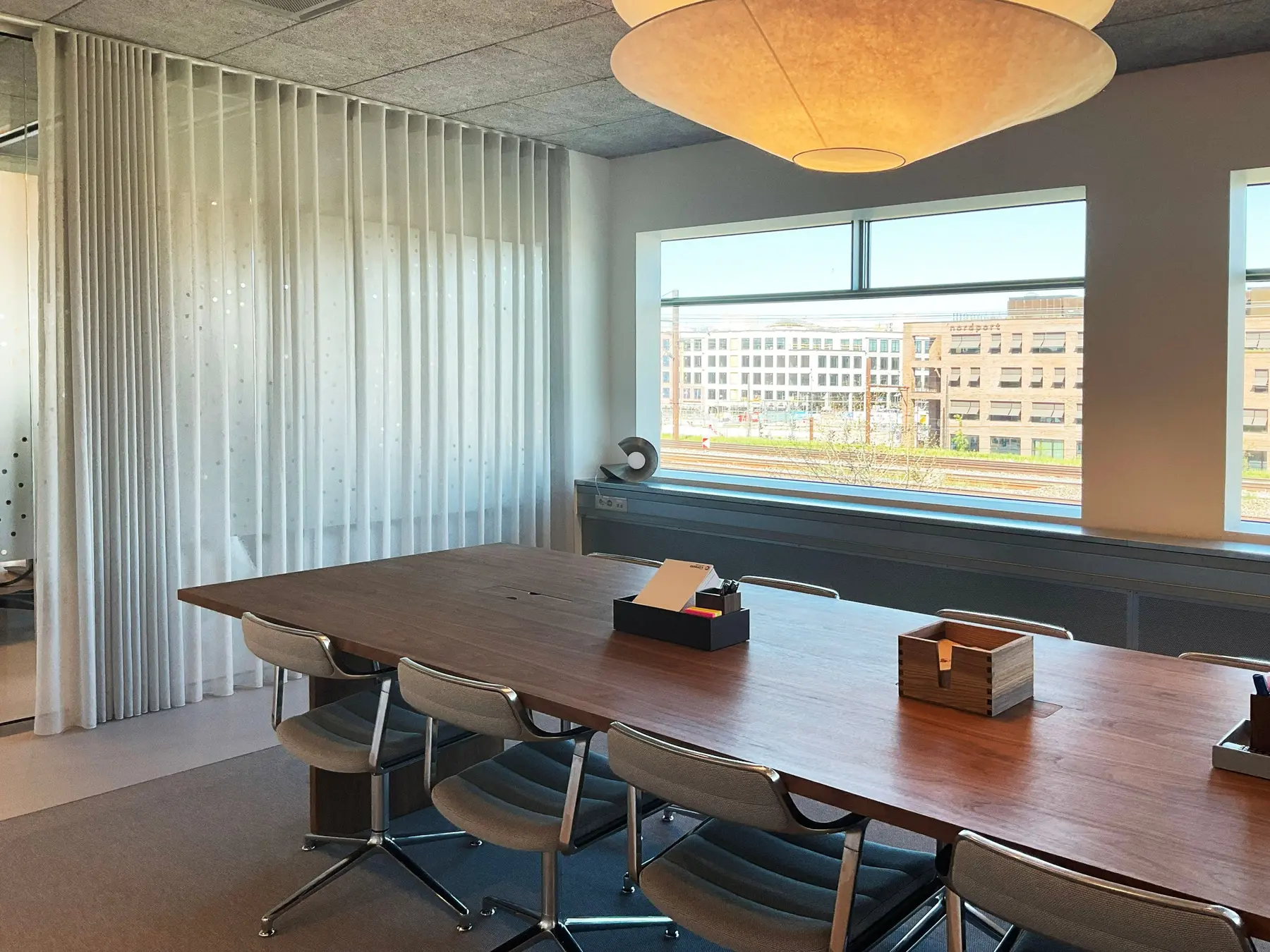 Meeting room in the Østerbro office with full-height transparent curtains