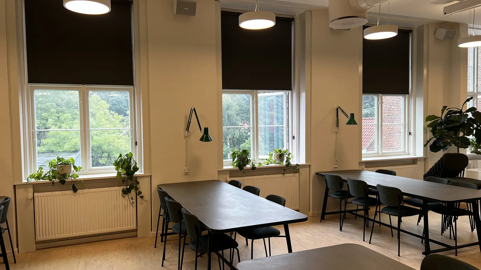 Teaching environment with even blackout roller blinds along the window sections